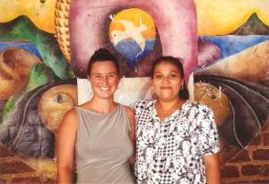 My teacher Flor and I stand in front of one of the painted walls of the school in San Juan del Sur, Nicaragua.